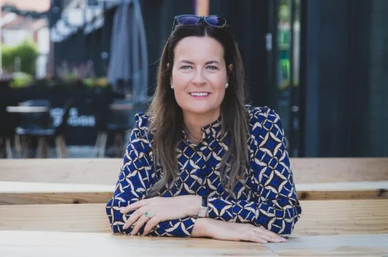 Zoe Holland seated at outdoor table