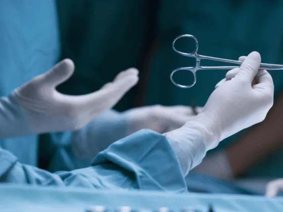 Hands of medical professional holding surgical instrument in operating room