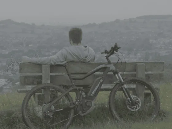 Stuart sat on bench with bike