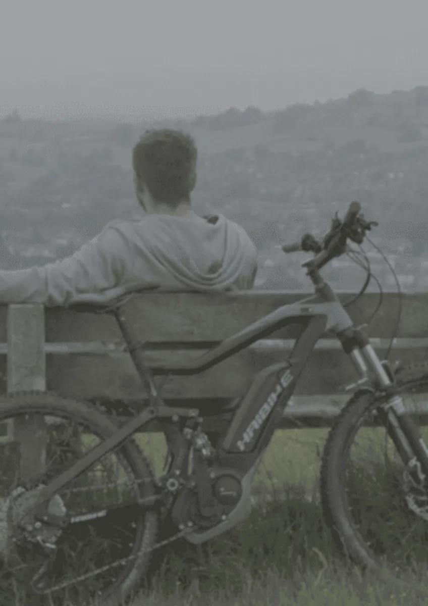 Stuart sat on bench with bike