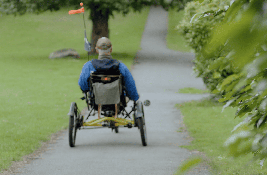 Dave cycling down a path