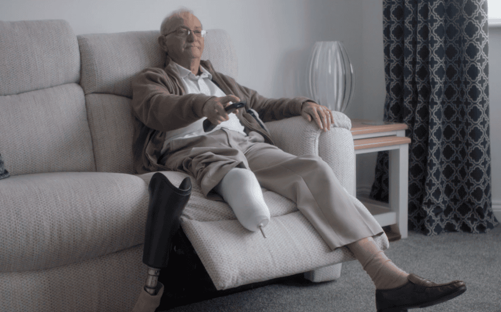 Gordon sat on his sofa with his new prosthetic leg