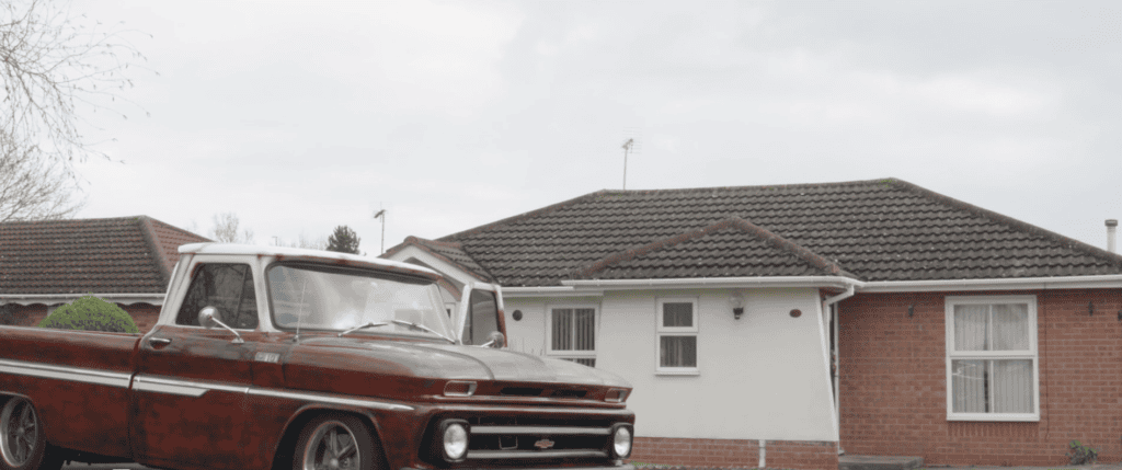 Robert's bungalow with a red car parked at the front