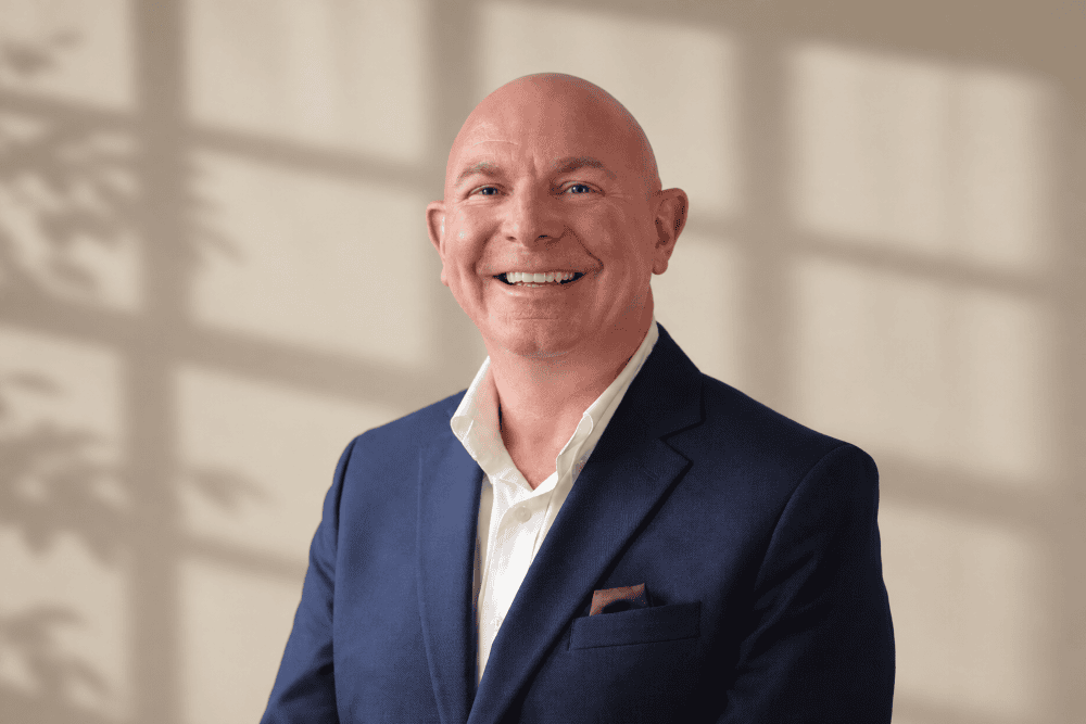 lawyer Stephen Horsley wearing blue blacker jacket and white shirt, smiling for a professional headshot.