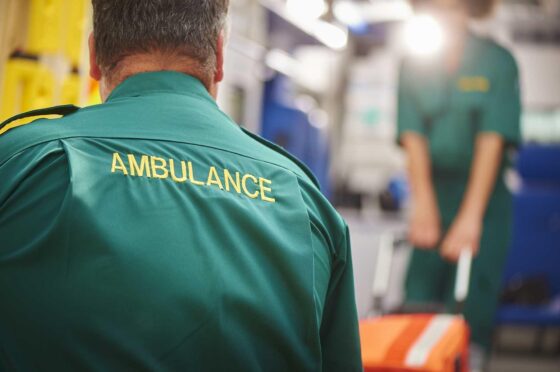 Ambulance worker in hospital emergency department