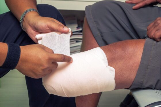 Bandage being wrapped around leg injury