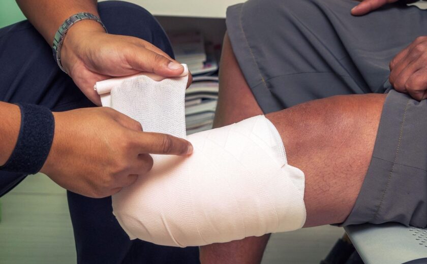 Bandage being wrapped around leg injury