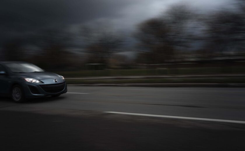 Car driving at speed on road