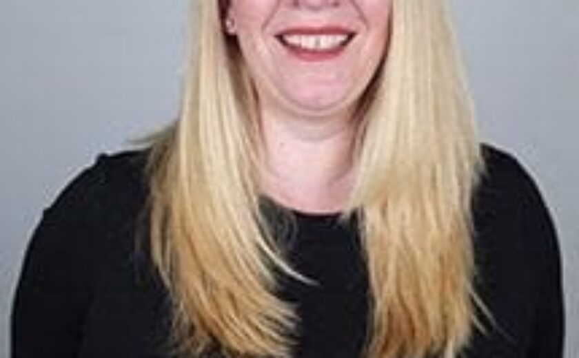 Caroline smiling in professional headshot