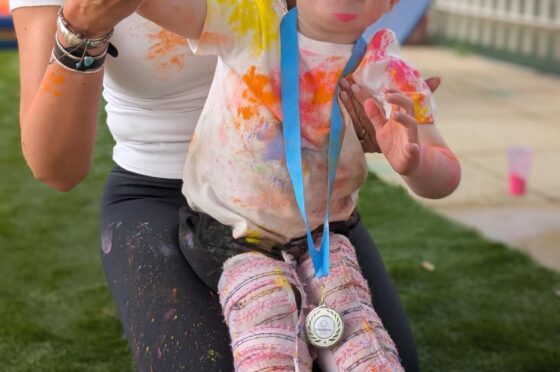 Child using supportive walker outdoors