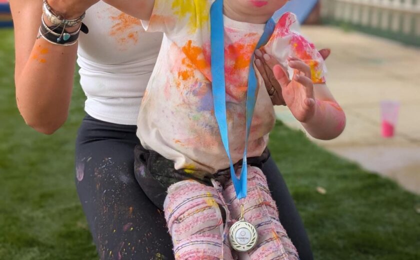 Child using supportive walker outdoors