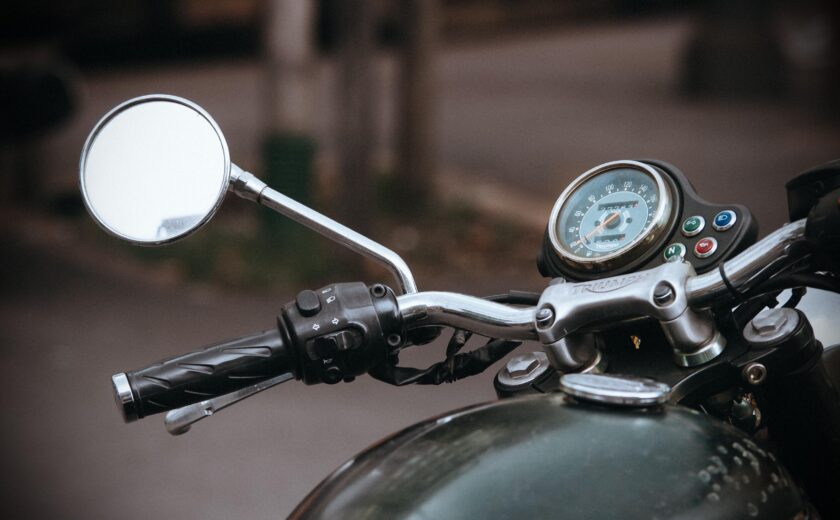 Close-up of motorcycle handlebars and mirror