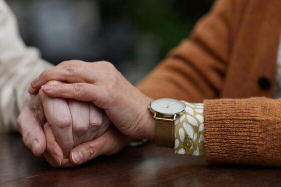 Close-up of one person comforting another