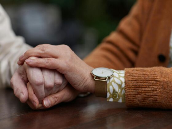 Close-up of one person comforting another