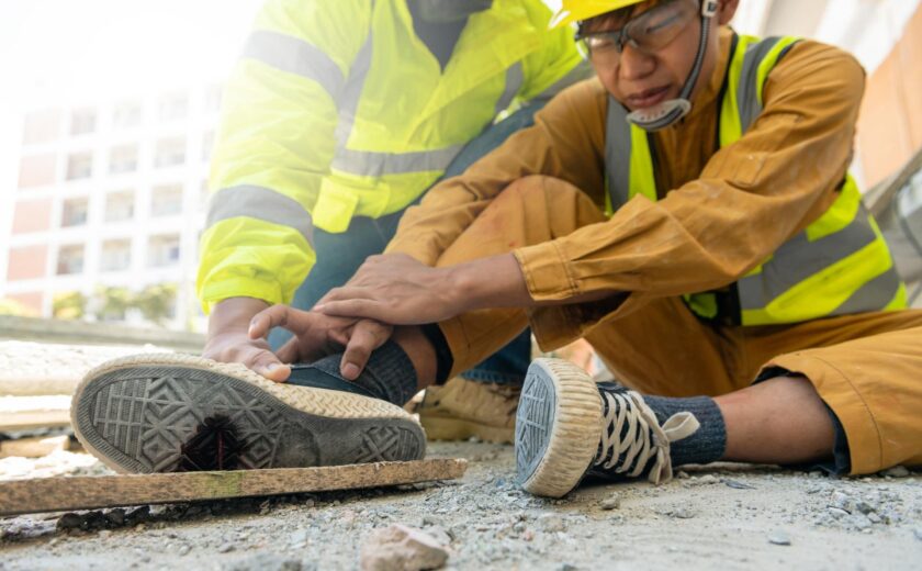 Construction workers helping injured colleague