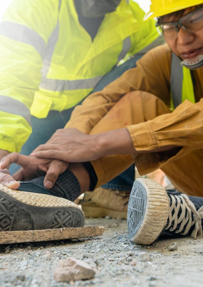 Construction workers helping injured colleague