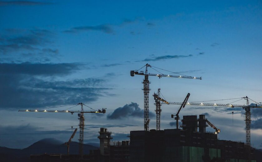 Cranes over construction site at dusk