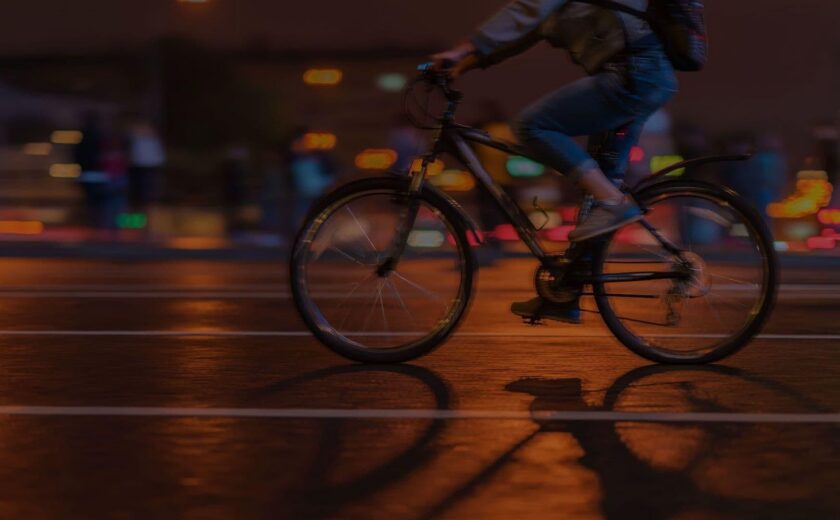 Cyclist riding through city at night