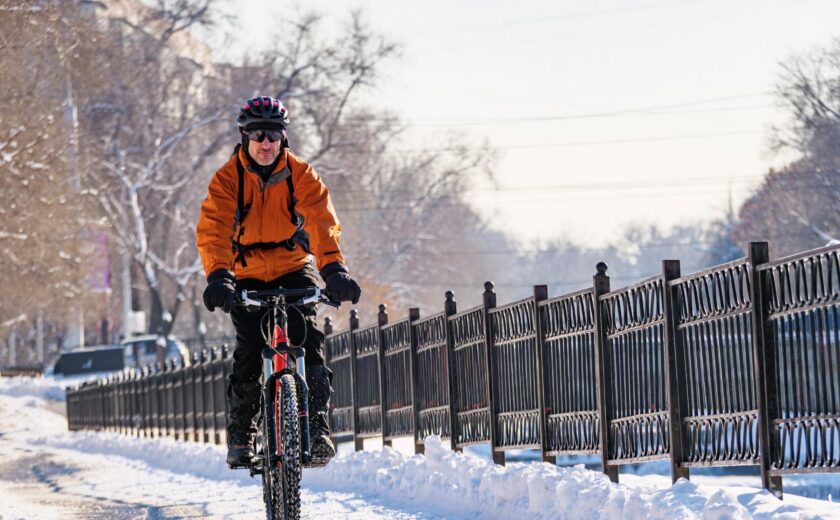 Cyclist riding through snow