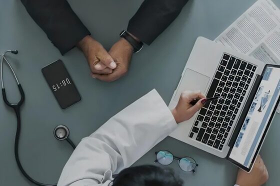 Doctor reviewing medical notes at consultation