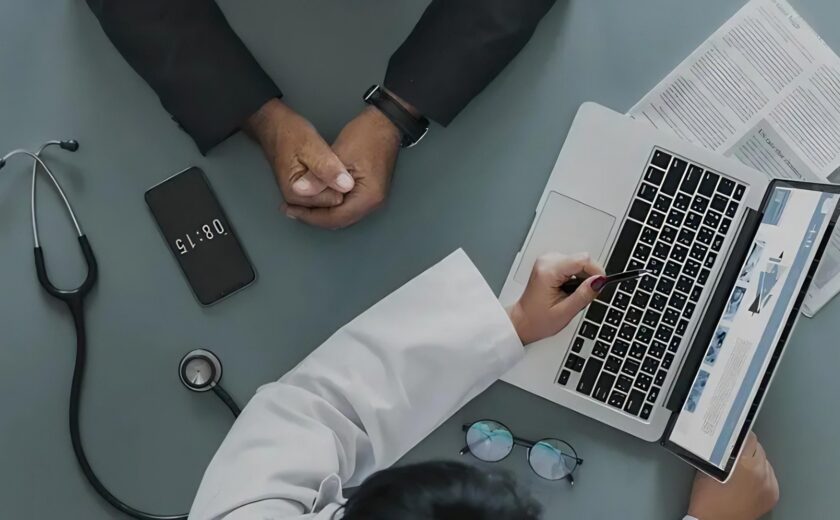 Doctor reviewing medical notes at consultation