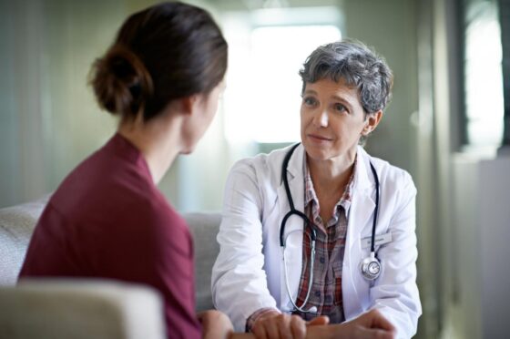 Doctor speaking with patient during consultation