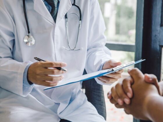 Doctor taking notes during patient consultation
