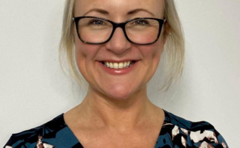 Dr JW smiling in professional headshot