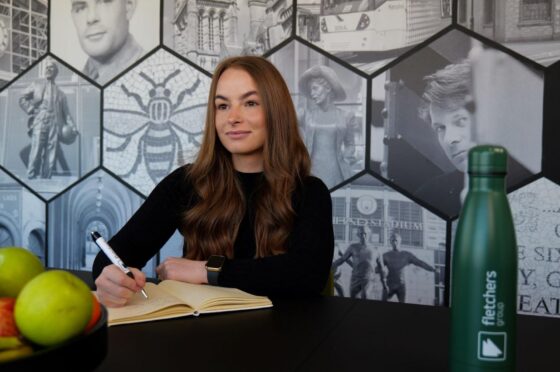 Emily Simpson writing at desk