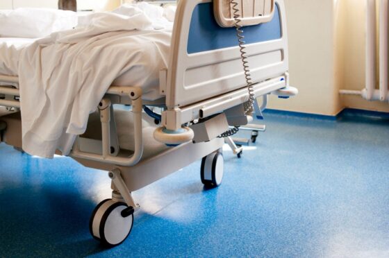 Empty hospital bed on ward