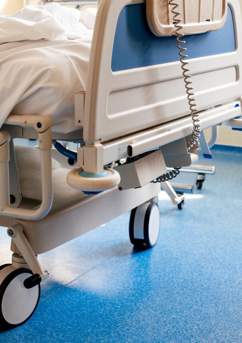 Empty hospital bed on ward
