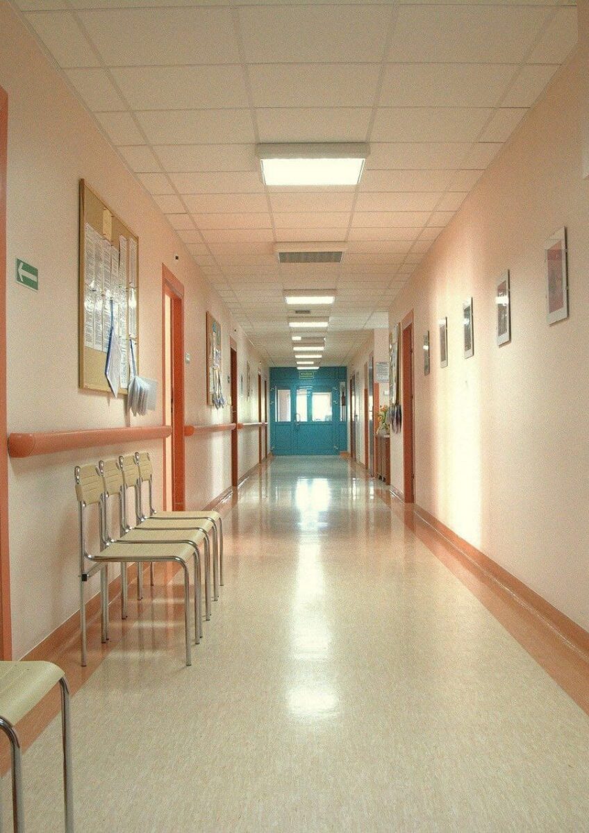Empty hospital corridor with chairs