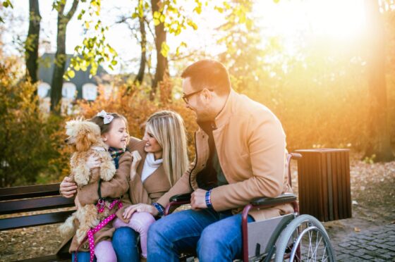 Family with child using wheelchair in park