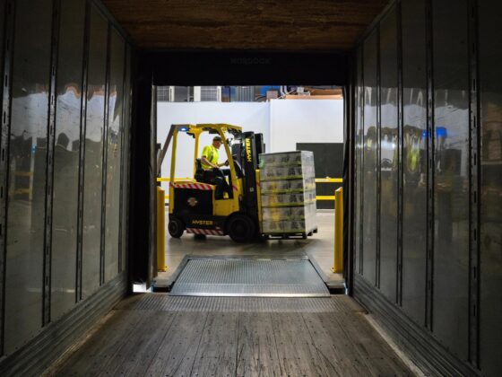 Forklift loading pallets inside lorry
