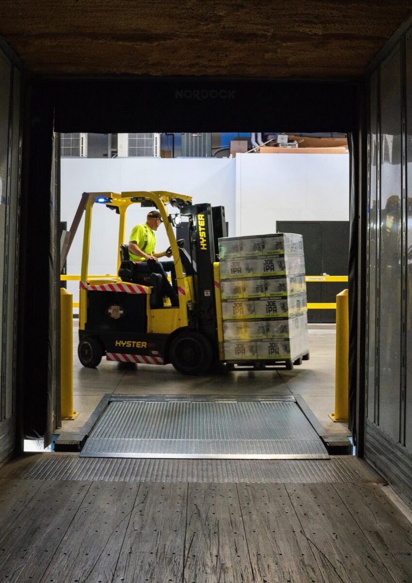 Forklift loading pallets inside lorry
