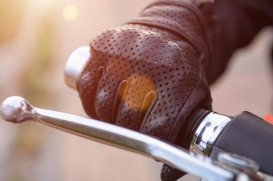 Gloved hand on motorcycle brake lever