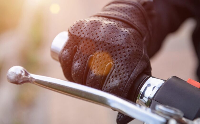 Gloved hand on motorcycle brake lever