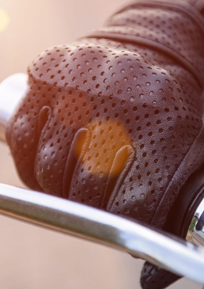 Gloved hand on motorcycle brake lever