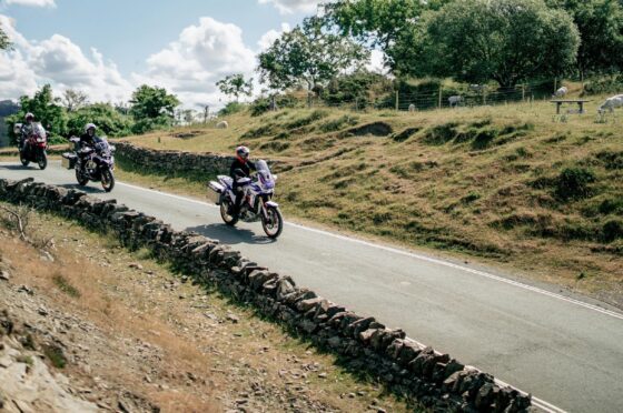 Group of motorcyclists riding through countryside