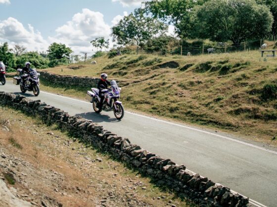 Group of motorcyclists riding through countryside