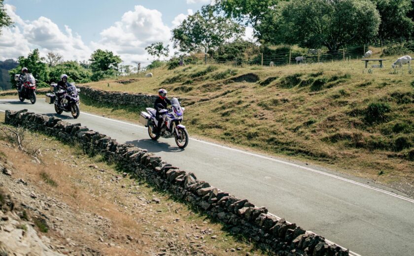 Group of motorcyclists riding through countryside