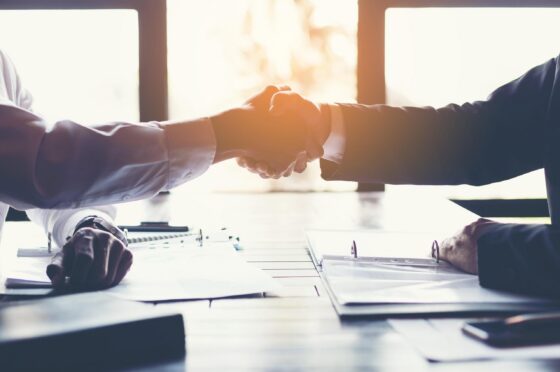 Handshake across office desk
