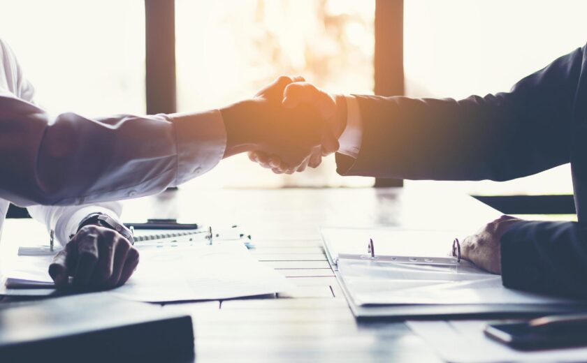 Handshake across office desk