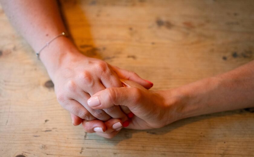 Holding hands being reassured