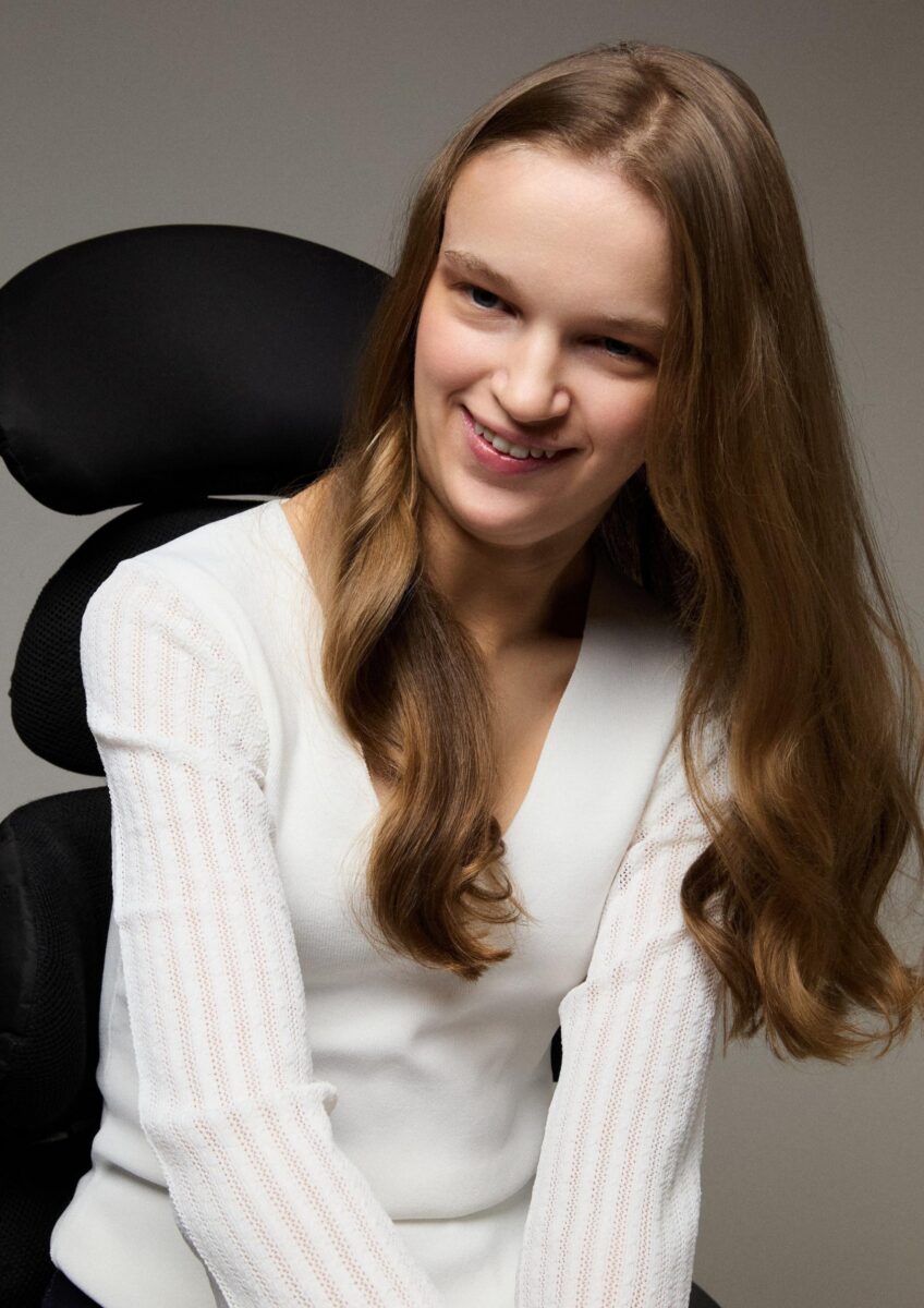 Holly seated in wheelchair smiling