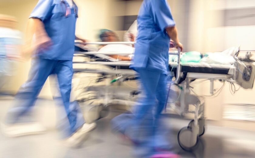 Hospital staff rushing patient on trolley