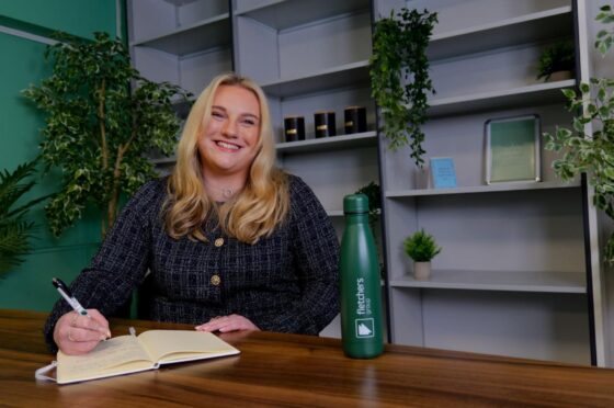 Jessica Roberts writing at desk