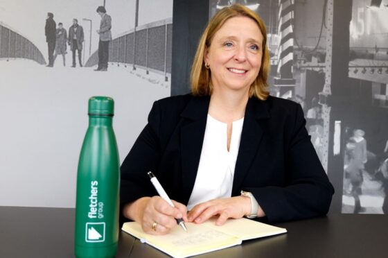 Jill Heywood writing at desk