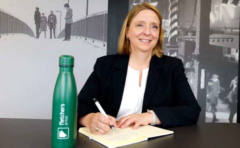 Jill Heywood writing at desk