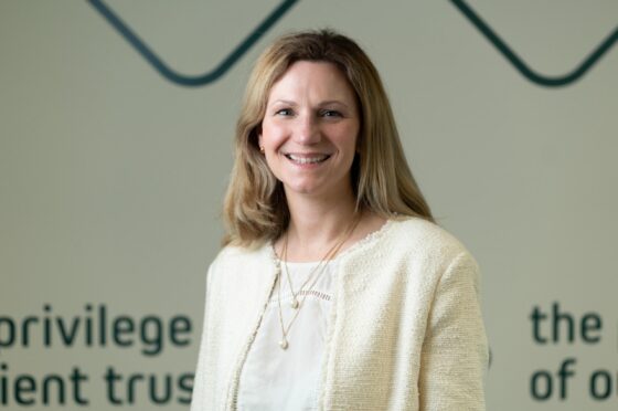 Kate Edwards smiling in front of Fletchers backdrop